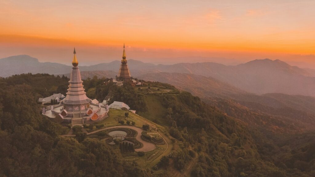 Temple from a drone shot in Thailand showing two similar looking temples next to each other during a beautiful sunset.